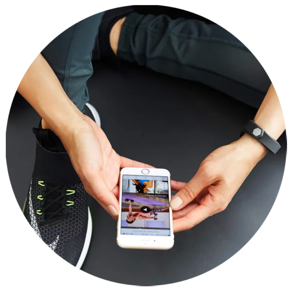 Woman watching an at home pilates video on her iphone